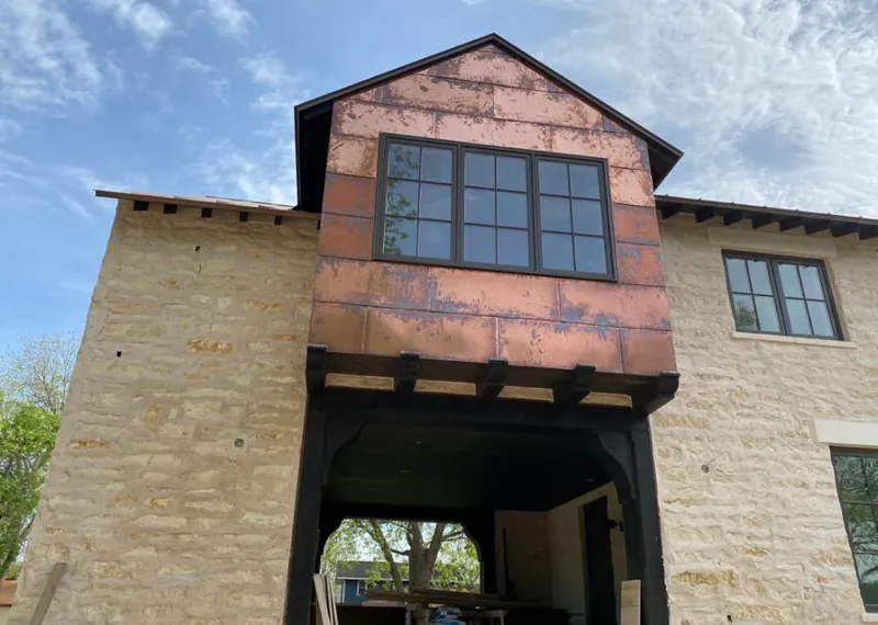 Copper metal panel facade on a stone building for Roof Repair in Buena Vista
