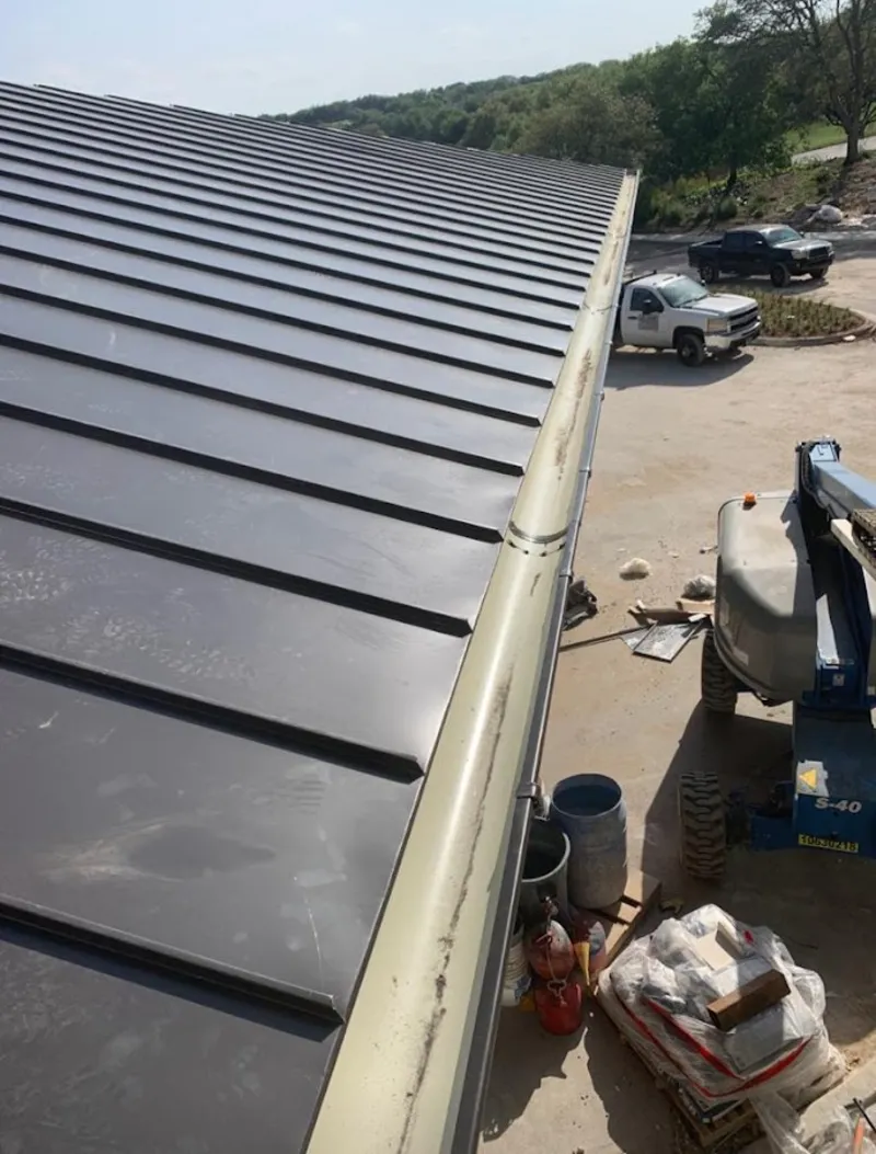 Standing seam panel and gutter detail on a metal roofing jobsite in Buena Vista